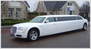 white limo parked outside of some houses