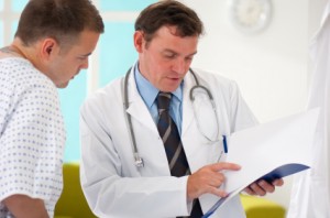 doctor looking over a file with his patient